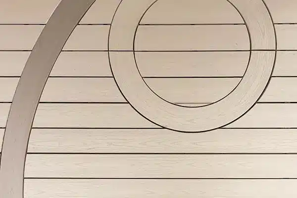 curved composite decking TimberTech Harvest Collection in Brownstone with small circle inlay